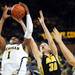 Michigan freshman Glenn Robinson III reaches for a rebound over Iowa sophomore Aaron White in the second half at Crisler Center on Sunday, Jan. 6. Michigan beat Iowa 95-67 in the Big Ten home opener. Melanie Maxwell I AnnArbor.com
